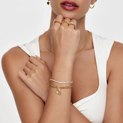 Pulsera con dije de cruz y piedra natal de perla