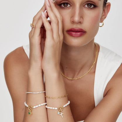 Pulsera con dije de cruz y piedra natal de perla
